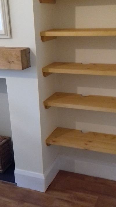 Pine alcove shelves beside fireplace