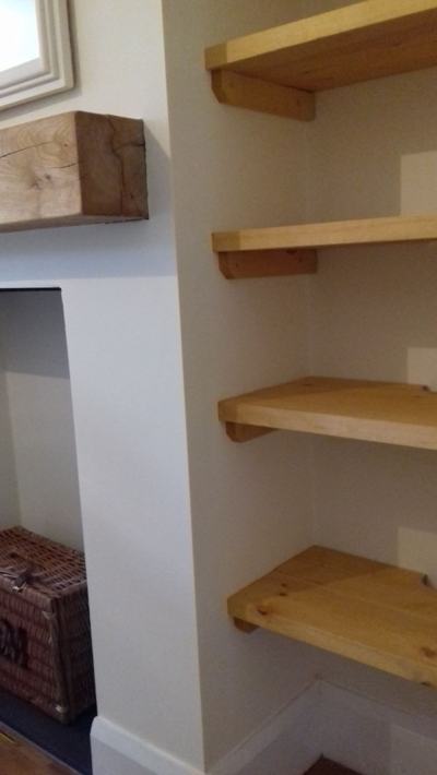 Alcove shelves with rustic beam mantel