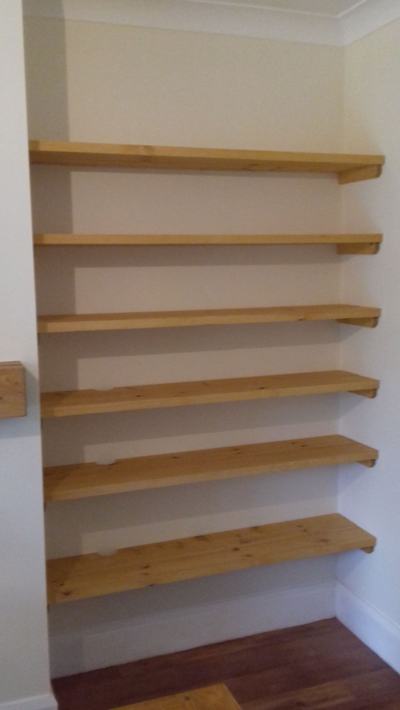 Full-height pine shelves in alcove
