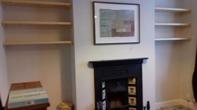 Alcove shelves beside sofa in living room