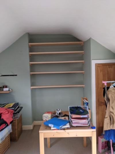 Shelves fitted in loft room with sloped ceiling