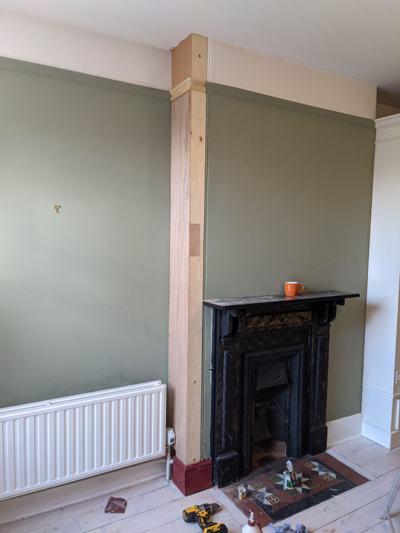 Boxing in pipes beside fireplace