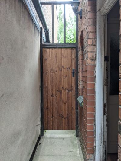 Wooden garden gate in passageway