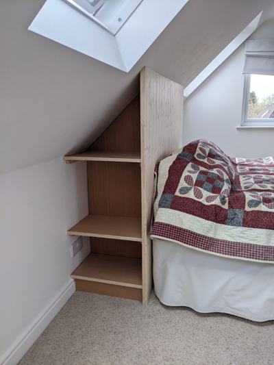 Bedside shelving in loft room