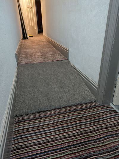 Skirting board and hallway carpeting