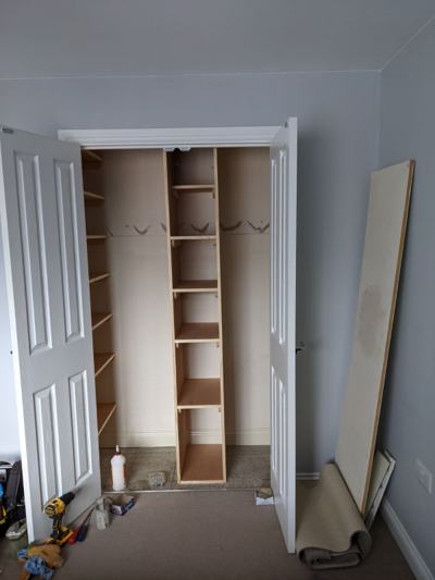 Shelves fitted in cupboard with household items