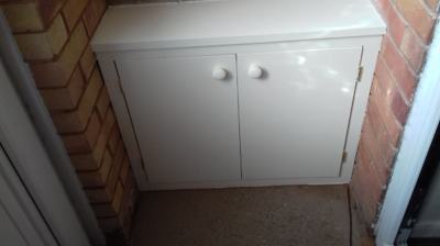 White painted small cupboard in alcove