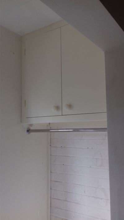 Wall-mounted cupboard with towel rail