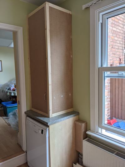 Tall cupboard on kitchen worktop